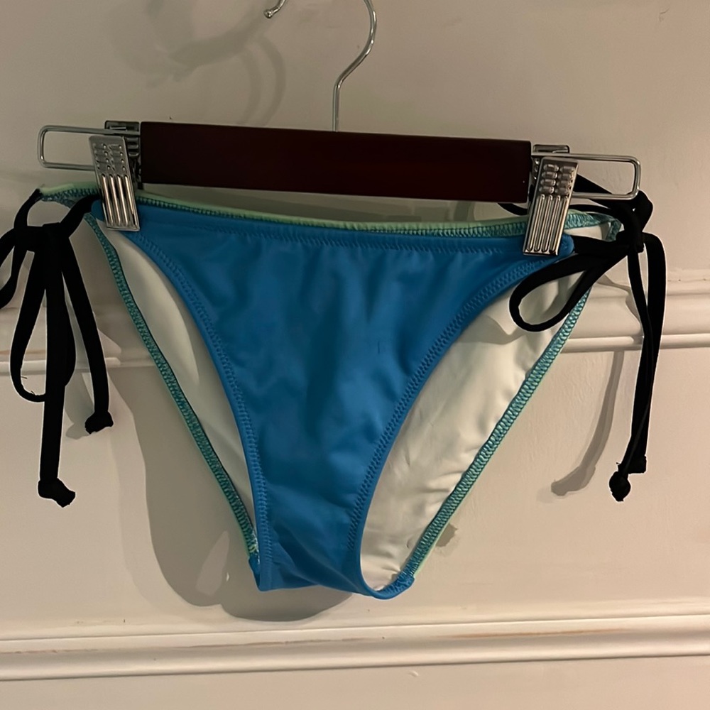 Green, black and blue swimsuit bottoms from pink